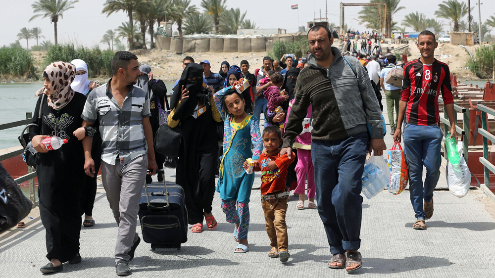 Thousands of people from Ramadi are pouring into Baghdad to escape the ongoing fighting between Iraqi security forces and ISIL [AP]