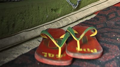 Claudio da Silva's slippers lie near his mattress in his impoverished home in a crime ridden favela in Rio [Priscilla Moraes/Al Jazeera]