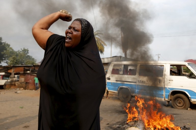 A woman throws a stone during a protest against Burundi President Pierre Nkurunziza and his bid for a third term in Bujumbura
