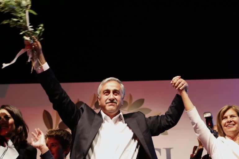 Turkish Cypriot newly elected leader Mustafa Akinci with his wife Miral wave to his supporters after he won the leadership election in the Turkish Cypriot breakaway north [AP]