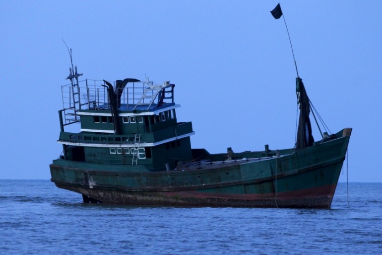 An abandoned boat which carried Rohingya and Bangladeshi migrants from Thailand is found off the coast near the city of Kuta Binje