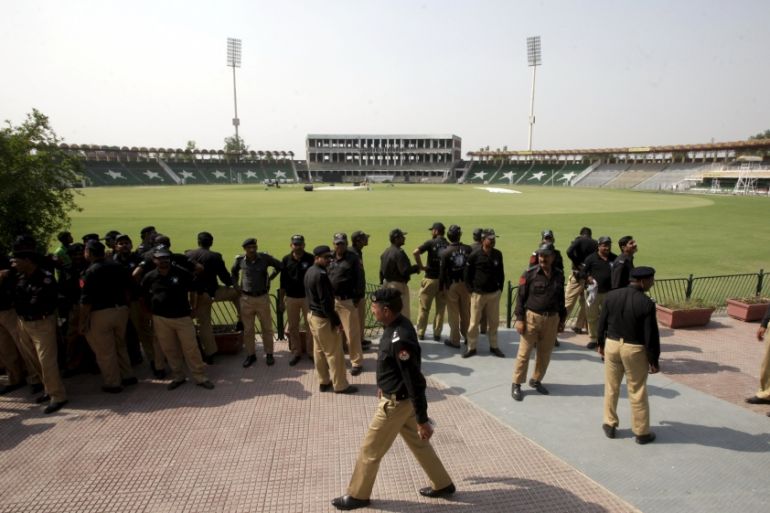 Policemen stand inside the Gaddafi Stadium during preparation ahead of cricket series between Pakistan and Zimbabwe in Lahore