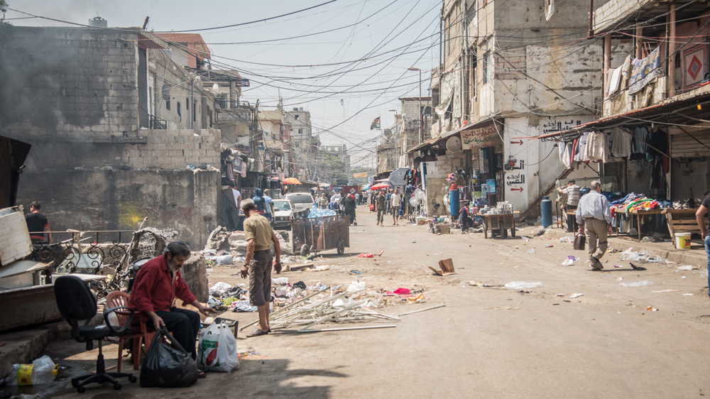 Piles of garbage and tangles of overhead wires crisscross Shatila's twisting alleyways [Wojtek Arciszewski/Al Jazeera]