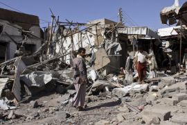 People inspect the site of an air strike in Yemen''s northwestern city of Saada
