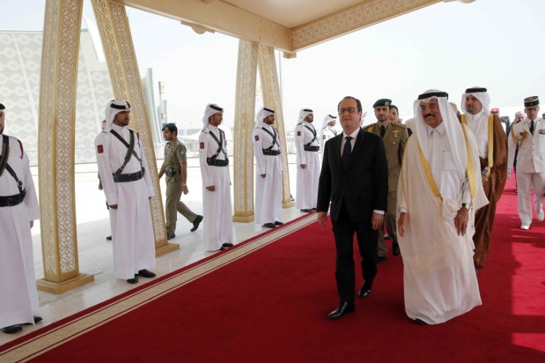 French President Hollande is greeted by Culture minister of Qatar Dr. Hamad Bin Abdulaziz Al-Kuwari at the Doha airport, Qatar