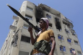 A Southern Popular Resistance fighter secures a street during fighting against Houthi fighters in the Dar Saad district of Yemen''s southern port city of Aden