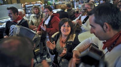 People play music in a bar the day before local elections [AP]
