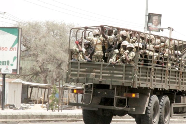 Soldiers are seen on a truck on the road in Maiduguri in Borno State, Nigeria