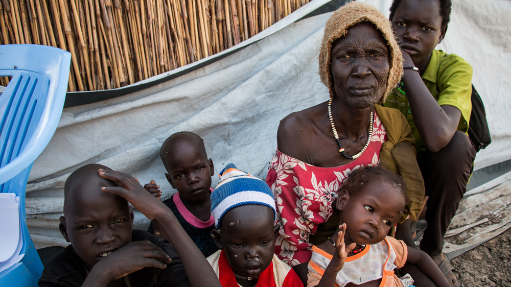 Nyakon arrived with her grandchildren at Bentiu camp, walking three days after their village was attacked [Ashley Hammer/Al Jazeera]