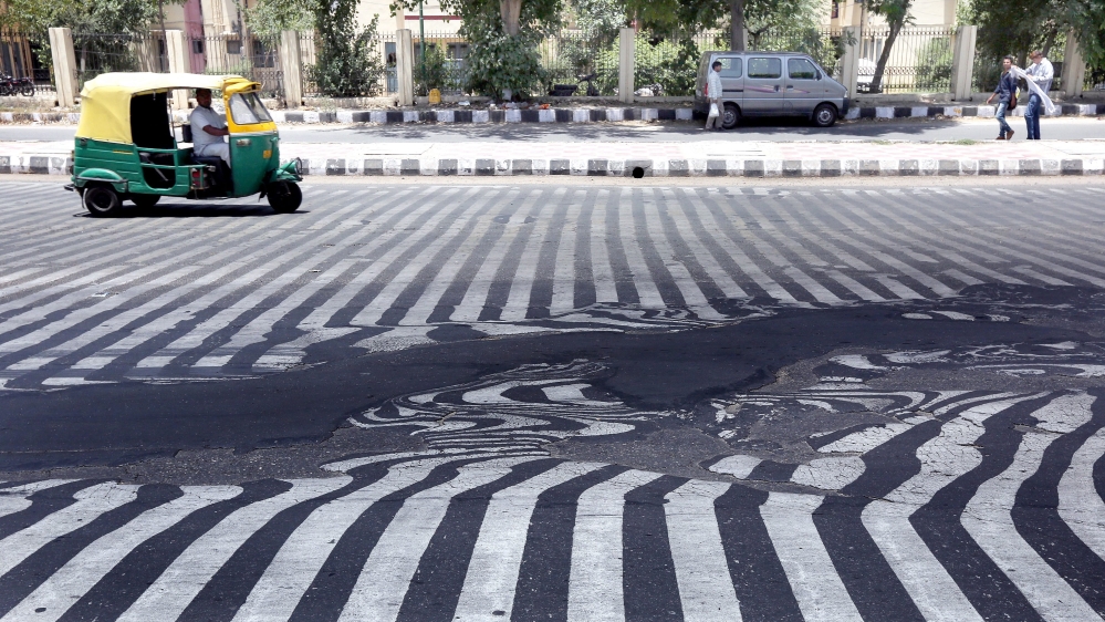 Road markings appear distorted as the asphalt starts to melt due to the high temperature in New Delhi [EPA]
