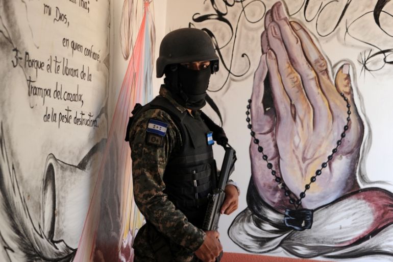 A militarised policeman takes part in the repression of youth gangs in Honduras [AFP]