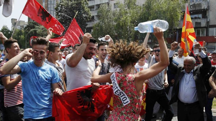 Anti-government protesters dance during a demonstration in Skopje