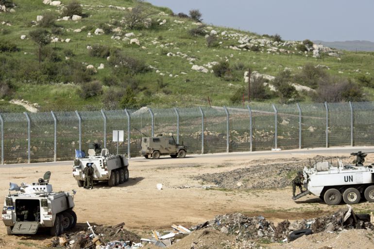 U.N peacekeepers from Ireland and Israeli soldiers patrol the border with Syria near the site of a Sunday Israeli airstrike,