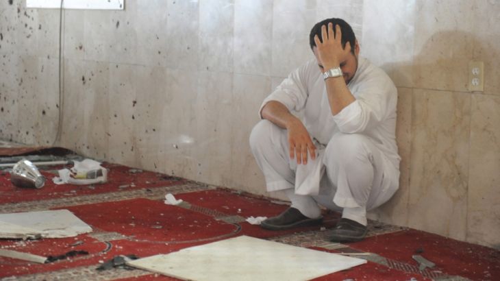 A family member of a slain victim mourns after arriving at the Imam Ali mosque in Saudi Arabia
