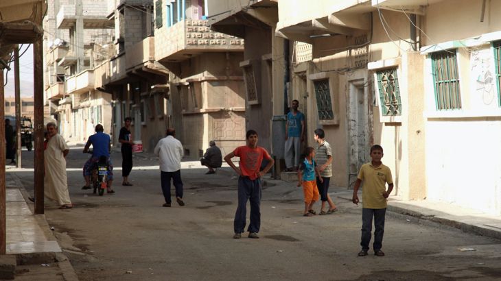 Residents walk in Palmyra city