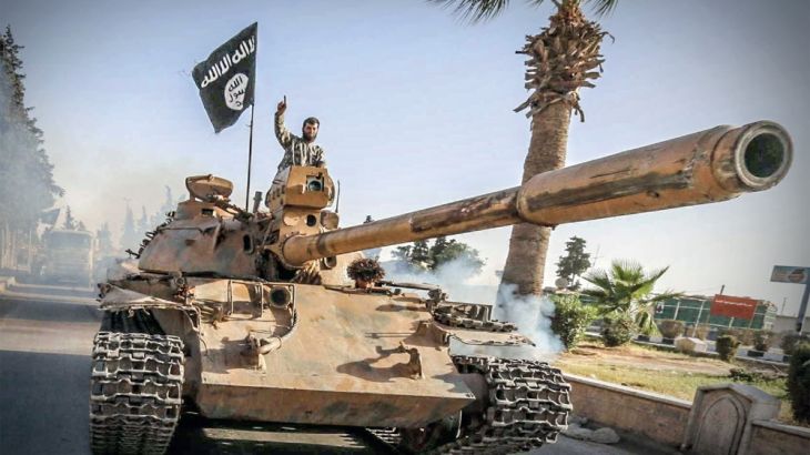 ISIL fighter riding a tank in Iraq