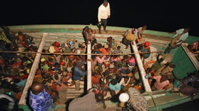 Refugees on a fishing vessel being taken to board the MV Liemba [Jessica Hatcher]