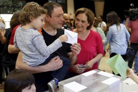 Adria Alemany, partner of Ada Colau "Barcelona en Comu" party leader and candidate for mayor of Barcelona, casts his vote next to their children in Barcelona