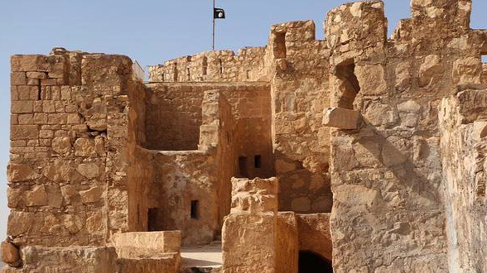 In this picture released on Friday, May 22, 2015 by the website of ISIL, shows the group's flag, top center, raised on the to top of Palmyra castle [AP]