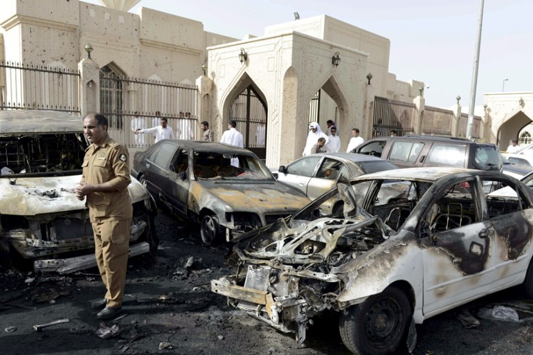 Policeman carries out an inspection after a car exploded near the Shi''ite al-Anoud mosque mosque in Saudi Arabia''s Dammam