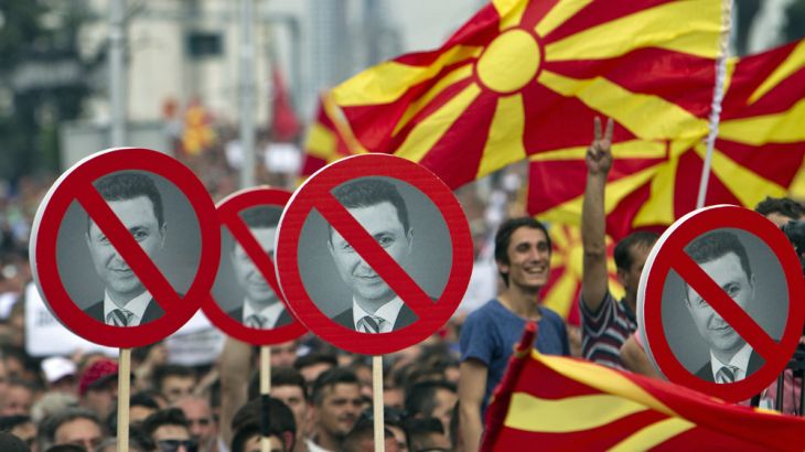 Macedonian protester hold signs with the picture of Macedonia''s Prime Minister Nikola Gruevski