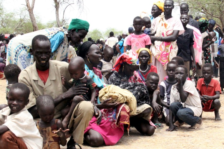 Residents displaced due to the recent fighting between government and rebel forces in the Upper Nile capital Malakal wait at a World Food Program (WFP) outpost where thousands have taken shelter