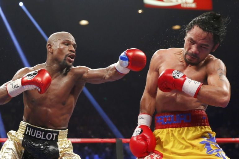 Mayweather, Jr. of the U.S. lands a left to the face of Pacquiao of the Philippines in the 11th round during their welterweight title fight in Las Vegas