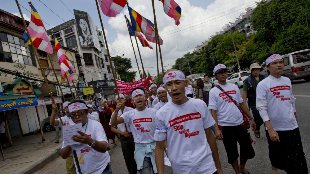 Protesters donned T-shirts emblazoned with the captions, 'Boat people are not from Myanmar' [AP]