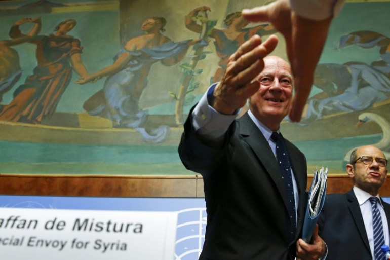 UN Special Envoy for Syria de Mistura shakes hands with a journalist after his news conference in Geneva