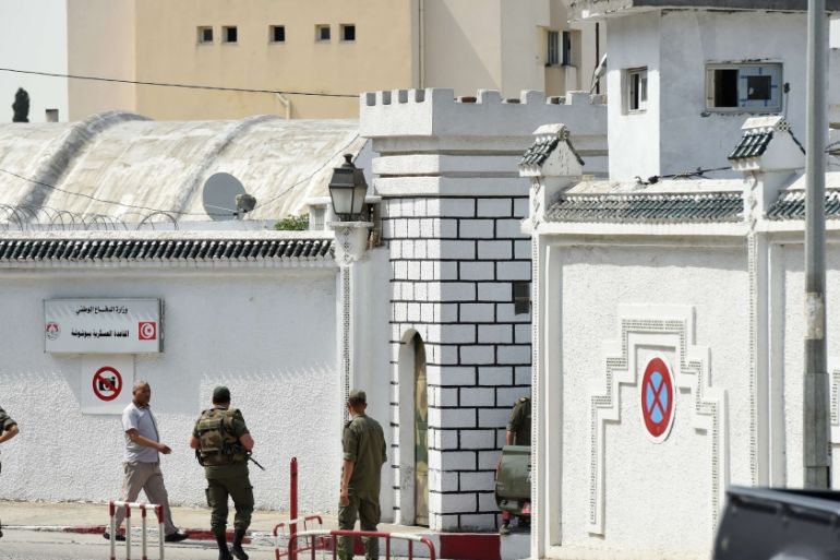 Tunisian soldiers stand guard outside the Bouchoucha army barracks in Tunis