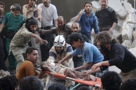 Syrian rescue workers and citizens carry a child on a stretcher from a building following a reported barrel bomb attack by Syrian government forces in Aleppo [AFP]