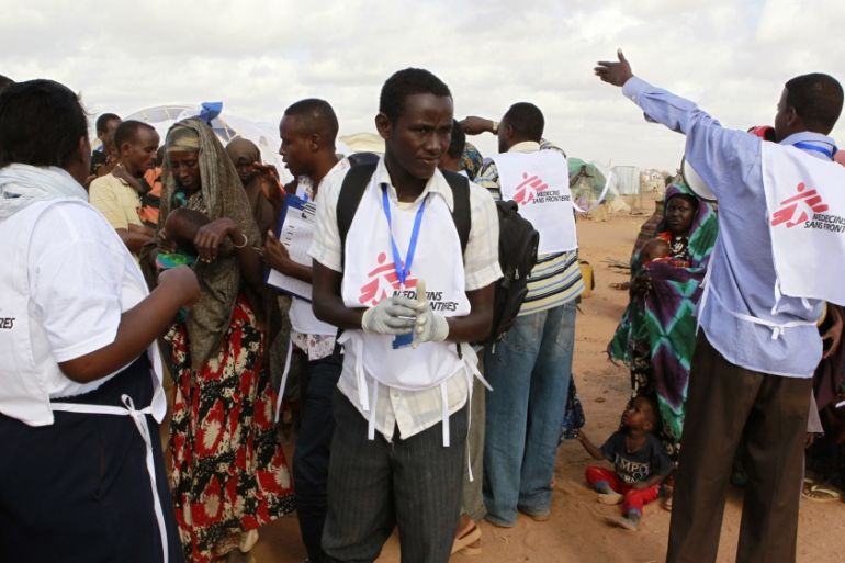 MSF workers direct newly arrived Somali refugees before they are administered polio vaccine at the Ifo extension refugee camp in Dadaab