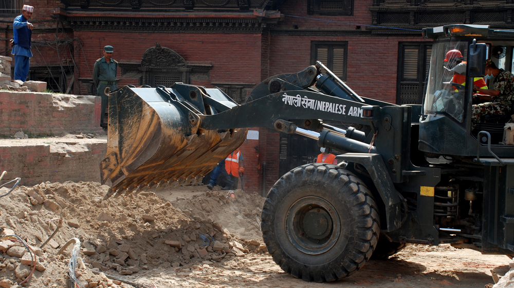 An army bulldozer clears debris from the historic pagoda in Durbar Square in Kathmandu [Ingrid Piper/Al Jazeera]