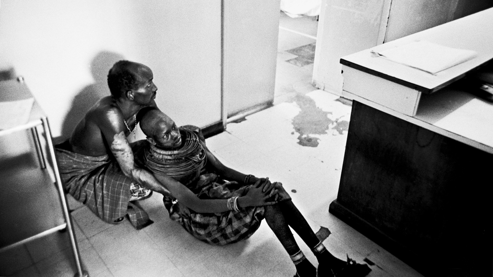 Juliana lies in her brother's arms on the floor of the hospital. Traditionally, once a Samburu girl has married, she leaves her family behind. But Juliana's brother insisted upon accompanying her to the hospital [Mariella Furrer]