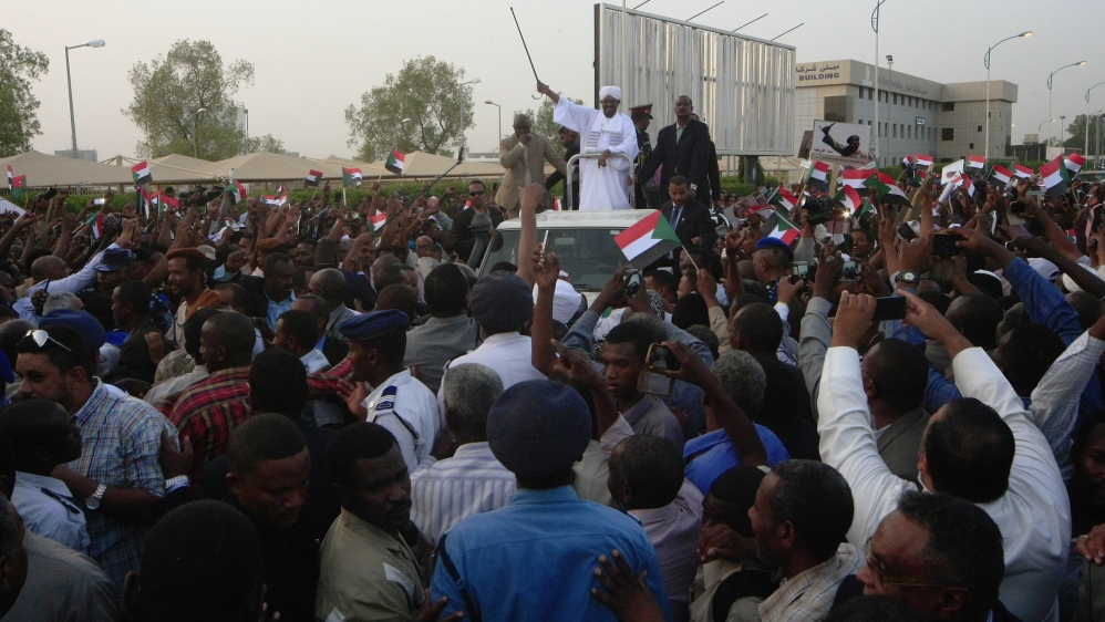 Bashir rode through a crowd of supporters upon his return to Sudan [The Associated Press]
