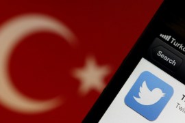 Twitter logo on an iPhone displayed next to a Turkish flag