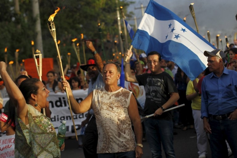 People take part in a march to demand the resignation of Honduras'' President Juan Hernandez in Tegucigalpa