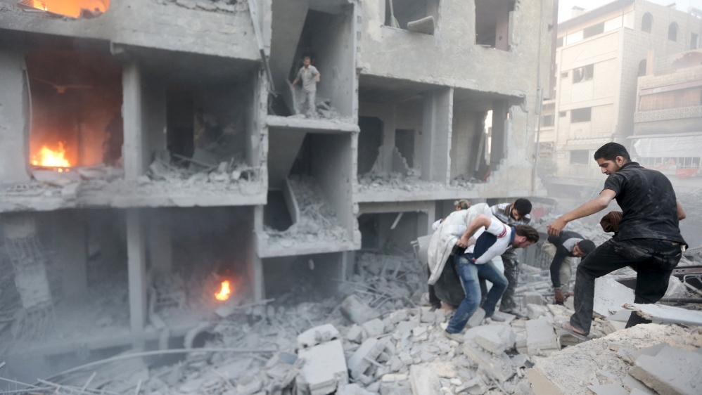  Men search for survivors at a site hit by what activists said was heavy shelling by the Syrian government on Douma [Reuters] 