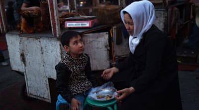 A Uighur mother and daughter at a night market [Getty]