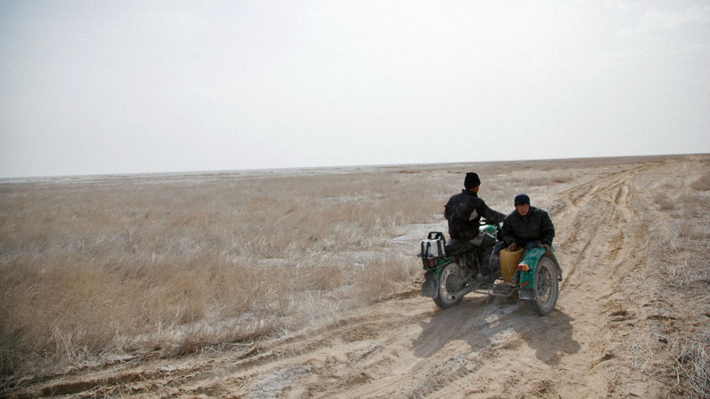 Two fishermen drive from the Western Aral shore to Muynak [Timur Karpov/Al Jazeera]