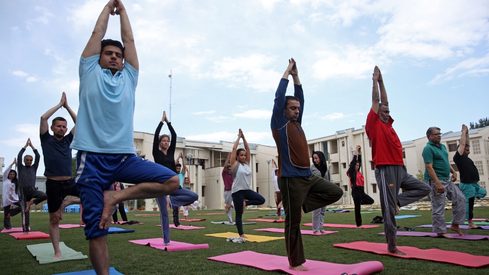 Afghans and foreigners attend yoga classes a day before International Yoga Day at the Indian embassy in Kabul [AP]