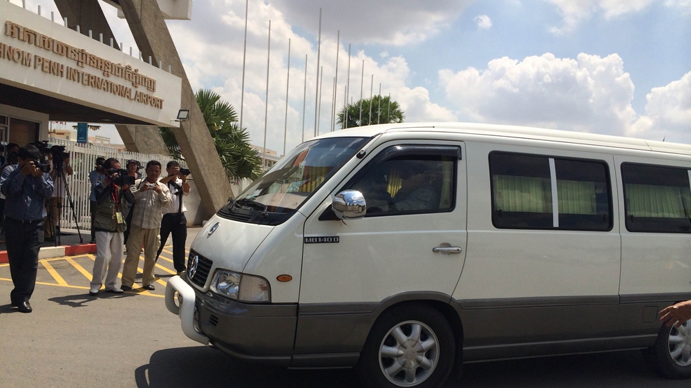 The four refugees were whisked from Phnom Penh International Airport in a minivan, dodging waiting reporters [Phorn Bopha/Al Jazeera]