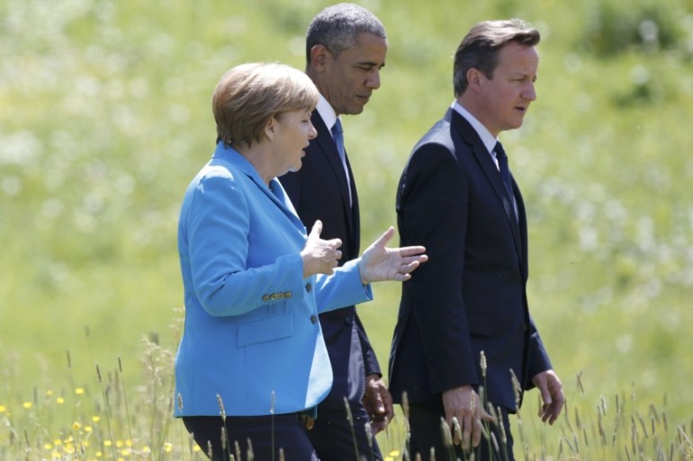German Chancellor Merkel chats with U.S. President Obama and British Prime Minister Cameron as they walk to attend their first meeting in the hotel castle Elmau in Kruen