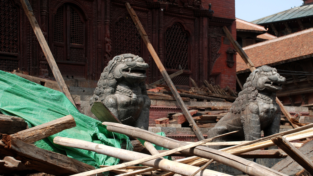 Temple lions and earthquake wreckage in Durbar Square, Kathmandu [Ingrid Piper/Al Jazeera]