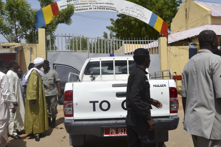 Security officers stand at the site of a suicide bombing in Ndjamena