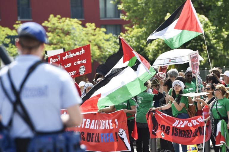 Palestinian activists protest in front of the Hallenstadium where the 65th FIFA Congress takes place in Zurich on May 29 [AFP]