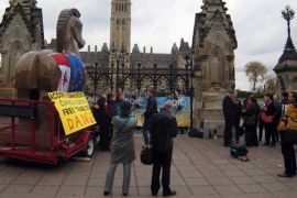 Activists in front of the Canadian parliament protest against negotiations between Canada and the EU on a free trade deal [AFP]