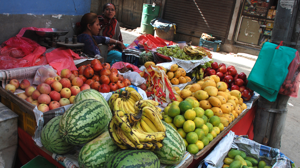 Women selling fruit on the streets of Kathmandu one month after the April 25 earthquake [Ingrid Piper/Al Jazeera]
