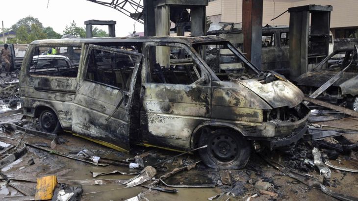 The charred wreckage of a minivan is seen at a gas station that exploded overnight killing around 90 people in Accra