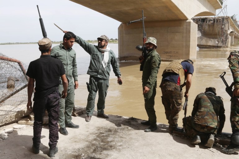 Iraqi security forces and Shiite militiamen on the Tigris River